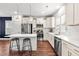 Bright kitchen boasts stainless steel appliances, white cabinets, a center island with seating, and ample counter space at 221 Douglas Falls Dr, Wendell, NC 27591