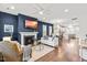 Open-concept living room with fireplace, modern decor, and hardwood floors throughout at 221 Douglas Falls Dr, Wendell, NC 27591