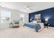 Serene main bedroom boasts a ceiling fan, accent wall, plush carpet, and bright windows at 221 Douglas Falls Dr, Wendell, NC 27591