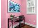 Home office featuring pink walls, a modern desk, an ergonomic chair, and natural light from a window at 221 Douglas Falls Dr, Wendell, NC 27591