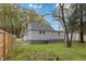 Back view of a gray home with a partially fenced yard, showcasing its outdoor space at 226 1St St, Henderson, NC 27536
