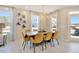 Elegant dining room with a wooden table, seating for eight, and modern light fixture at 2265 Kettle Falls Sta, Apex, NC 27502