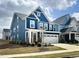Beautiful two-story home with blue siding, stone accents, and a two-car garage at 2265 Kettle Falls Sta, Apex, NC 27502