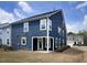 Exterior of a home featuring modern blue siding, bright white trim, and a well-manicured lawn at 2265 Kettle Falls Sta, Apex, NC 27502