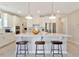 Modern kitchen with white cabinets, stainless steel appliances, and a large kitchen island at 2265 Kettle Falls Sta, Apex, NC 27502