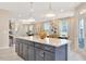 Open concept kitchen with a large island, quartz countertops, and modern lighting at 2265 Kettle Falls Sta, Apex, NC 27502
