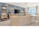 Bright living room with blue accent wall, modern furniture, large TV, and ample natural light at 2265 Kettle Falls Sta, Apex, NC 27502