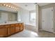 Bright bathroom features a large mirror, double vanity, and soaking tub at 2321 Stony Bottom Dr, Raleigh, NC 27610