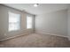 Spacious bedroom filled with light from two windows and plush carpeting at 2321 Stony Bottom Dr, Raleigh, NC 27610