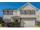 Charming two-story home featuring brown shutters, stone accents and a white garage door at 2321 Stony Bottom Dr, Raleigh, NC 27610
