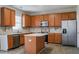 Well-equipped kitchen with an island, stainless appliances, and wood cabinetry at 2321 Stony Bottom Dr, Raleigh, NC 27610