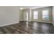 Bright living room with new, gray flooring and a white front door at 2321 Stony Bottom Dr, Raleigh, NC 27610