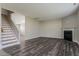 A spacious living room featuring a fireplace, staircase, and recently updated flooring at 2321 Stony Bottom Dr, Raleigh, NC 27610