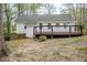 View of the back exterior of the home with a wooden deck and access to the yard at 2400 Hemlock Cir, Clayton, NC 27520