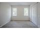 Inviting bedroom with ample natural light from two windows and a convenient closet at 2400 Hemlock Cir, Clayton, NC 27520