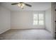 A bright bedroom features plush carpeting, a ceiling fan, and a window with natural light at 2400 Hemlock Cir, Clayton, NC 27520