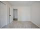 Neutral bedroom with plush carpeting and a glimpse into a hallway and closet at 2400 Hemlock Cir, Clayton, NC 27520