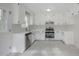Bright kitchen featuring stainless steel appliances, white cabinets, and modern countertops and fixtures at 2400 Hemlock Cir, Clayton, NC 27520