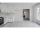 A view of the kitchen, with appliances and an entry to the living area at 2400 Hemlock Cir, Clayton, NC 27520