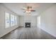 Living room features a fireplace, and large windows providing natural light at 2400 Hemlock Cir, Clayton, NC 27520