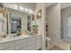 Bathroom featuring double sinks, a large mirror, and a view into the bedroom at 2521 Friedland Pl # 201, Raleigh, NC 27617
