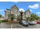 Apartment building featuring siding and brick exterior with well-maintained landscaping and parking at 2521 Friedland Pl # 201, Raleigh, NC 27617