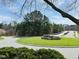 Community entrance featuring a well-manicured green space with a fountain and directional signage at 2521 Friedland Pl # 201, Raleigh, NC 27617