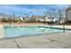Community pool enclosed by a fence, offering a refreshing amenity for residents on a sunny day at 2521 Friedland Pl # 201, Raleigh, NC 27617