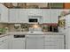Functional kitchen featuring white cabinetry, appliances, and tile flooring at 2521 Friedland Pl # 201, Raleigh, NC 27617