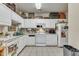 Functional kitchen featuring white cabinetry, appliances, and tile flooring at 2521 Friedland Pl # 201, Raleigh, NC 27617