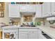 Bright kitchen featuring white cabinetry, countertops, and standard appliances at 2521 Friedland Pl # 201, Raleigh, NC 27617