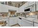 White kitchen with upper cabinets and standard appliances at 2521 Friedland Pl # 201, Raleigh, NC 27617