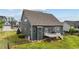 Exterior backyard view, displaying home with a small deck, fenced in yard, and green grass at 265 Beckwith Ave, Clayton, NC 27527