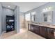 Bathroom with double sinks, granite countertops, tiled floors, and a tiled walk-in shower at 265 Beckwith Ave, Clayton, NC 27527
