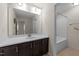 Well-lit bathroom features a large mirror over a vanity with dark cabinets and a shower/tub combo at 265 Beckwith Ave, Clayton, NC 27527