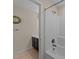 Bathroom featuring white tiled shower/tub combo, toilet and sink with an antique clock on the wall at 265 Beckwith Ave, Clayton, NC 27527