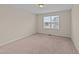 Bedroom features soft carpet, a window with blinds, and a neutral color scheme at 265 Beckwith Ave, Clayton, NC 27527
