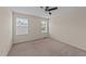Bedroom features neutral paint, carpet floors, two windows, and a ceiling fan at 265 Beckwith Ave, Clayton, NC 27527