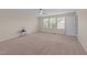 Bedroom with large windows offering natural light, plush carpet, and a ceiling fan at 265 Beckwith Ave, Clayton, NC 27527