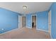 Bedroom with carpet floors, neutral paint, and multiple doors at 265 Beckwith Ave, Clayton, NC 27527