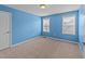 This bedroom features carpeted flooring, two windows, and a ceiling fan at 265 Beckwith Ave, Clayton, NC 27527
