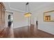Formal dining area featuring hardwood floors, crown molding, and stylish lighting fixture at 265 Beckwith Ave, Clayton, NC 27527