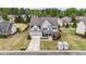 Charming two-story home boasts a well-manicured lawn, attached garage, and inviting curb appeal at 265 Beckwith Ave, Clayton, NC 27527