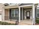 Inviting front porch featuring black railings, brick accents, and a welcoming entrance at 265 Beckwith Ave, Clayton, NC 27527
