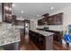 Spacious kitchen featuring dark cabinetry, granite countertops, and a center island at 265 Beckwith Ave, Clayton, NC 27527