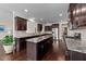 Gourmet kitchen featuring dark cabinets, stainless appliances, and granite countertops at 265 Beckwith Ave, Clayton, NC 27527