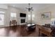 Bright living room featuring hardwood floors, fireplace, and natural light from large windows at 265 Beckwith Ave, Clayton, NC 27527