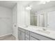 Bright bathroom with double sink vanity, quartz countertops, and a large mirror at 272 Hiking Hill Ln, Garner, NC 27529