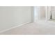 Empty bedroom with neutral carpet and paint, showing the entrance to the laundry room at 272 Hiking Hill Ln, Garner, NC 27529