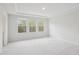 Bright, spacious bedroom featuring neutral colors and a bank of windows for ample natural light at 272 Hiking Hill Ln, Garner, NC 27529
